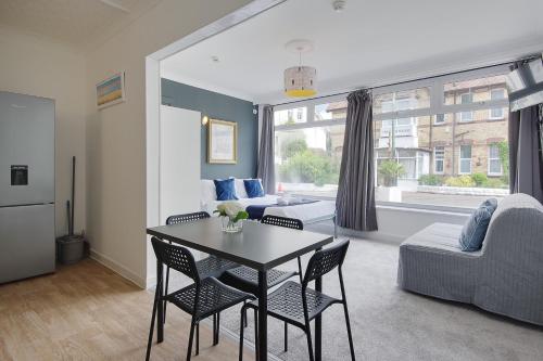 a living room with a table and chairs and a couch at Serenity Hotel in Bournemouth