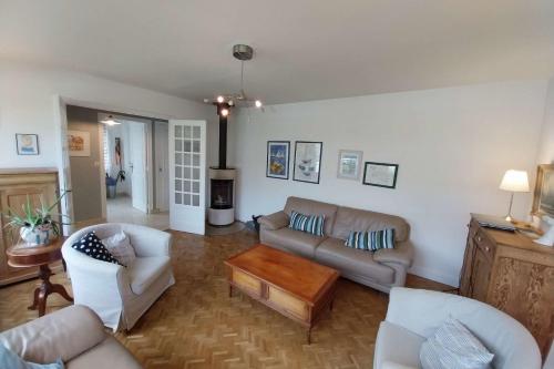 a living room with two couches and a fireplace at Beautiful family house in Meucon in Meucon
