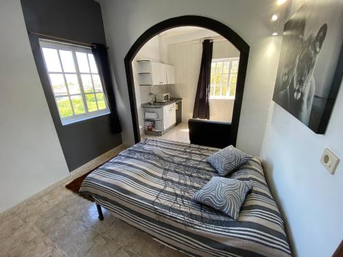 a bedroom with a bed with pillows on it at Apartamentos Blanco Y Negro in A Guarda