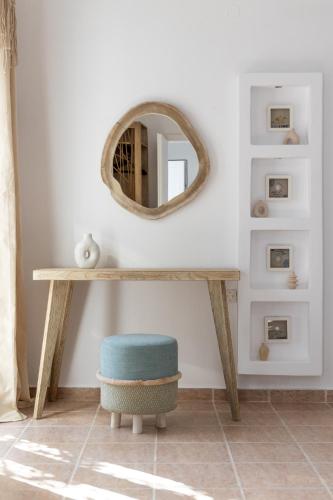 a dressing table with a mirror and a stool at Summer Residence in Provatas