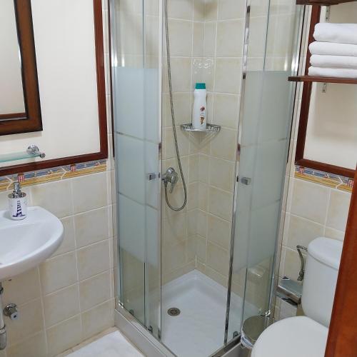 a shower in a bathroom with a sink and a toilet at Que rico... Puerto Rico! in Puerto Rico de Gran Canaria