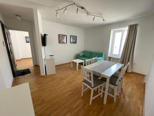 a dining room and living room with a table and chairs at Apartment Tartini in Piran