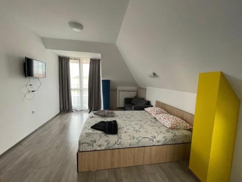 a bedroom with a bed and a yellow cabinet at ZaraApartHotel in Sofia