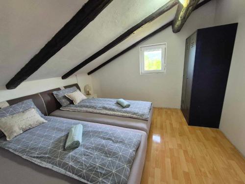a bedroom with two beds and a window at Vila Antik in Ilirska Bistrica