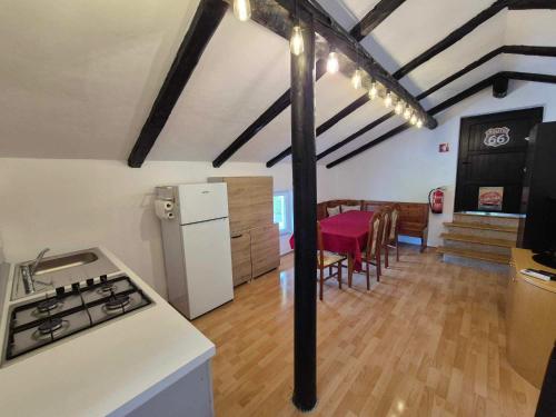 a kitchen and dining room with a stove and refrigerator at Vila Antik in Ilirska Bistrica
