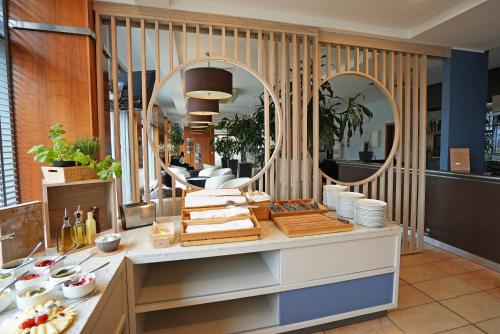 uma loja com um balcão com pratos e espelhos em Hotel Oliwski em Gdańsk