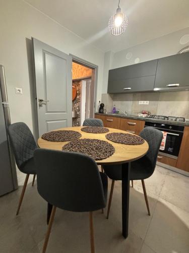 a kitchen with a table and chairs in a room at Iancu in Brăila