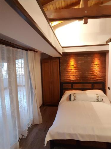 a bedroom with a large white bed with a window at Saint Johns Hill Boutique Ephesus in Selcuk