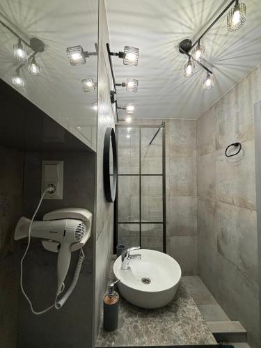 a bathroom with a sink and a shower at Iancu in Brăila