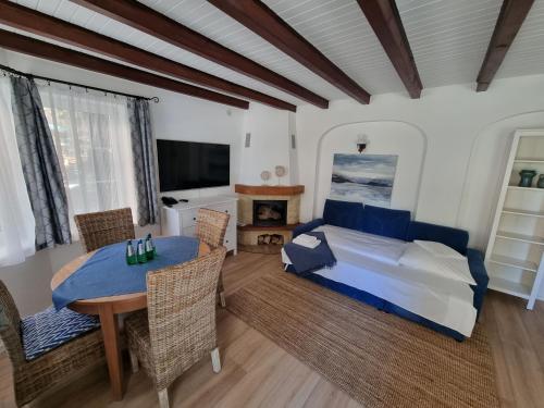 a bedroom with a bed and a table and chairs at Villa Sedina in Rewal