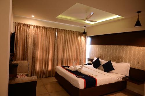 a bedroom with a large bed and a window at Canyon sun in Chennai
