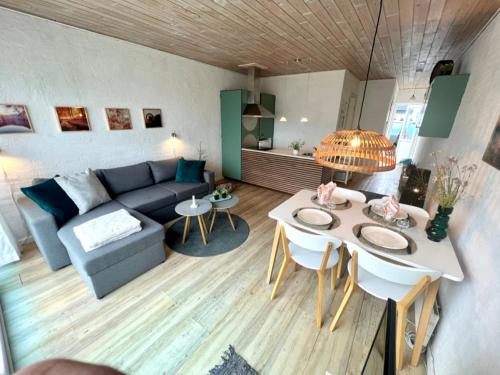 a living room with a couch and a table at Agger Tange Feriecenter lejligheder - 100 m fra Vesterhavet in Vestervig