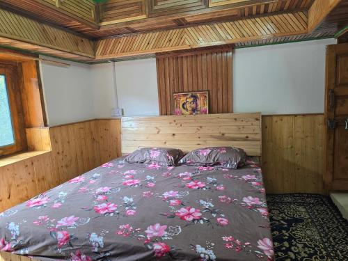 a bedroom with a large bed in a room at Kin Vatika Homestay in Kalpa