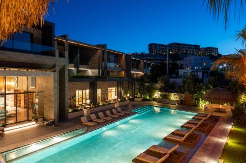 a swimming pool with lounge chairs and a building at Arts Hotel Bodrum Yalikavak in Yalıkavak