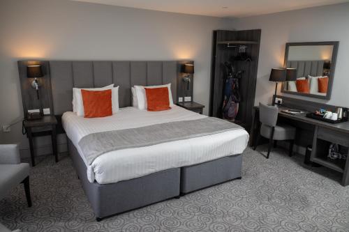 a hotel room with a large bed and a desk at Hawkstone Park in Wem