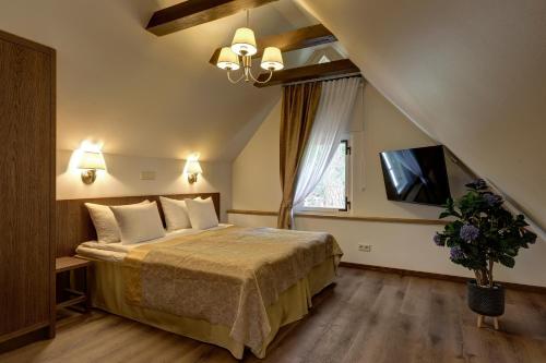 a hotel room with a bed and a tv at Vihula Manor Country Club & Spa in Vihula
