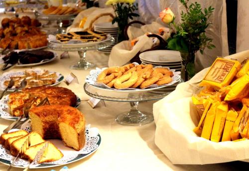 a table topped with plates of food and bread at Hotel Gardenia in Romano Canavese