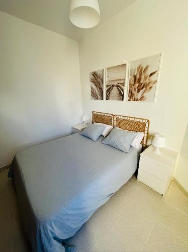 a bedroom with a large bed with two pillows at Mareal in La Restinga