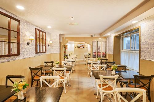 a row of tables and chairs in a restaurant at Huttons Hotel, Victoria London in London