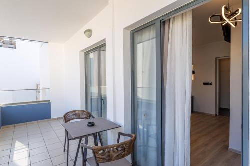 a room with a table and chairs and a window at Medusa Apartments in Rethymno Town