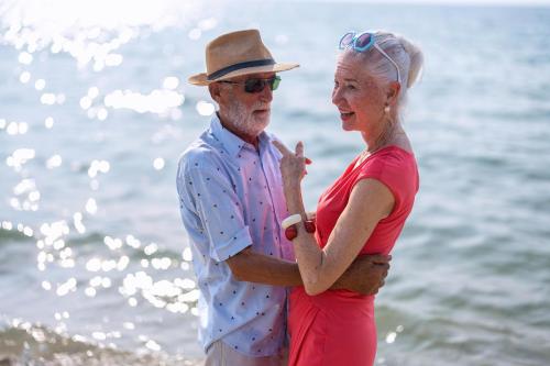 a man and a woman standing on the beach at Wonderful 6 Berth Caravan In Norfolk At Heacham Beach, Ref 21012E in Heacham