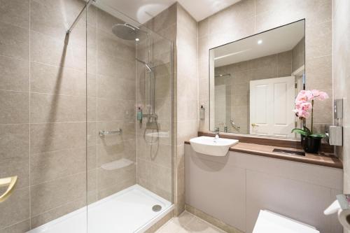 a bathroom with a shower and a sink and a mirror at Dunsilly Hotel in Antrim