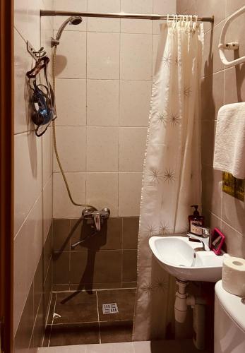 a bathroom with a shower and a sink at Guest room in Old Town in Vilnius