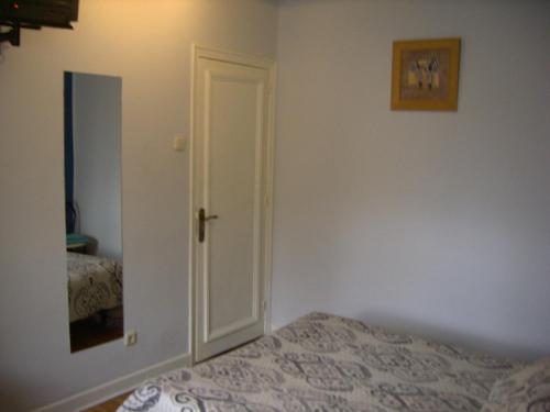 a bedroom with a door leading to a bed at Pensión Gema in Irún