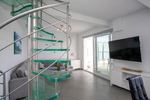 a living room with a glass shelf and a tv at N&L VILLAS in Pyrgi
