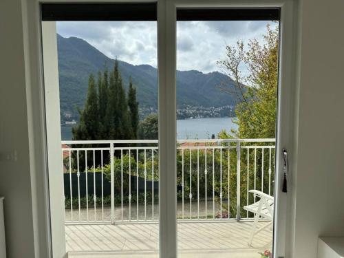 a window view of a lake from a house at Luxury Apartment SOLE in Moltrasio