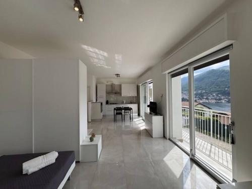 a large living room with a view of a balcony at Luxury Apartment SOLE in Moltrasio