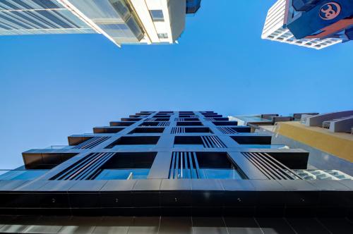 a tall building with a blue sky in the background at Noru Hotel Malta - Adults Only Hotel in St Julian's