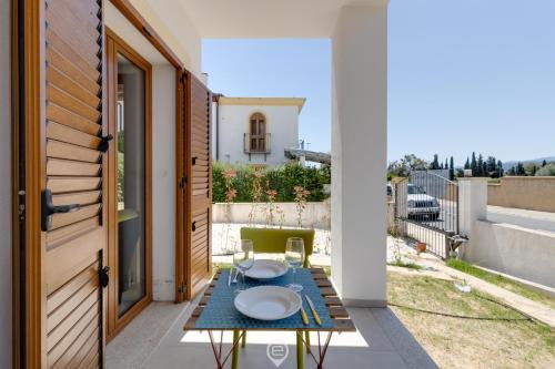 a patio with a table with plates on it at Lemon Apartment 2 in Àrbatax