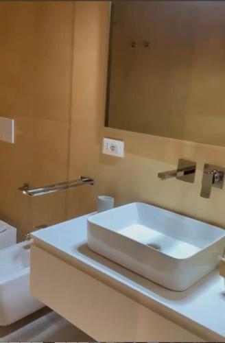 a bathroom with a white sink and a mirror at I SECOLARI in Sannicandro di Bari