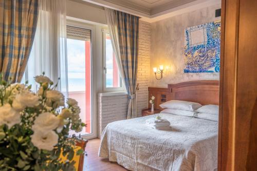 a bedroom with a bed and a large window at Art Hotel Santa Lucia in Termoli