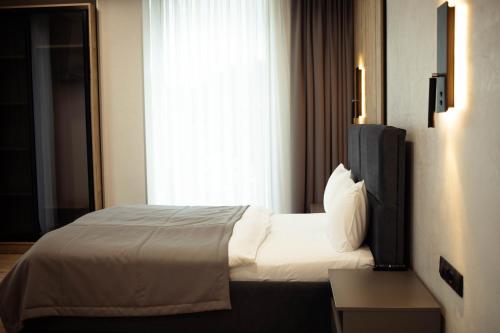 a hotel room with a bed and a window at Rest&Ski Spa Resort in Bukovel