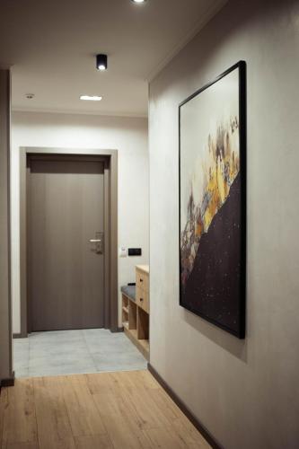a hallway with a large painting on the wall at Rest&Ski Spa Resort in Bukovel