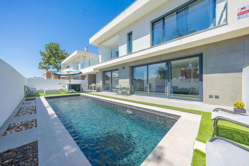 an image of a house with a swimming pool at Black Pool House just 10 minutes away from the beach in Amora