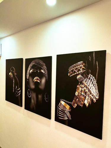 four pictures of a woman on a wall at Luxury Central Baba Apartment in Shkodër