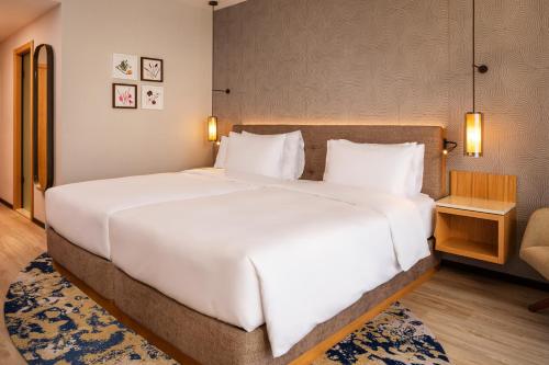 a large white bed in a hotel room at Hyatt Regency Pravets Resort in Pravets