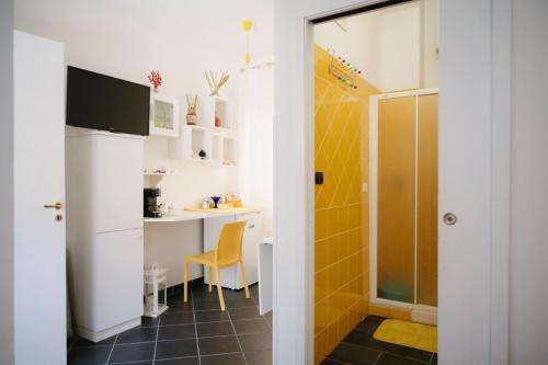 a small kitchen with a table and a yellow tile floor at Stop And Go in Scilla