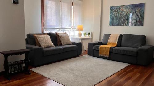 a living room with two couches and a table at Duplex 122m2, 4 dormitorios, 2 baños completos, Wifi 1GB in Mundaka