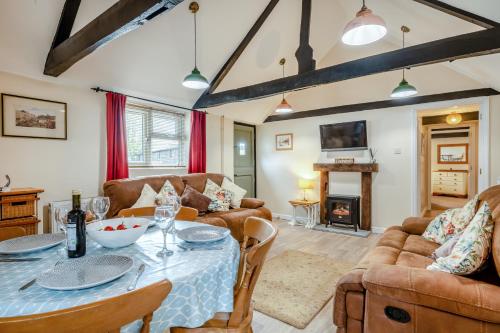 a living room with a table and chairs and a fireplace at The Old Dairy & The Old Stables in Thetford