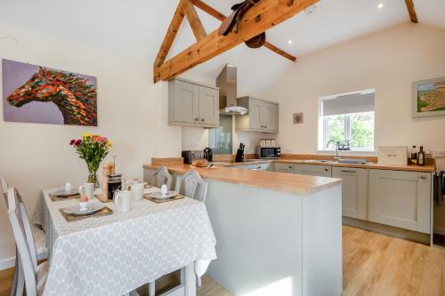 a kitchen with a table and a counter top at The Old Dairy & The Old Stables in Thetford