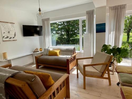 a living room with a couch and a chair at Whitebeam, Moor and Sea Holidays, beautiful views over Exmoor in Lynton