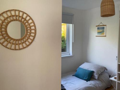 a mirror and a bed in a room with a window at Whitebeam, Moor and Sea Holidays, beautiful views over Exmoor in Lynton