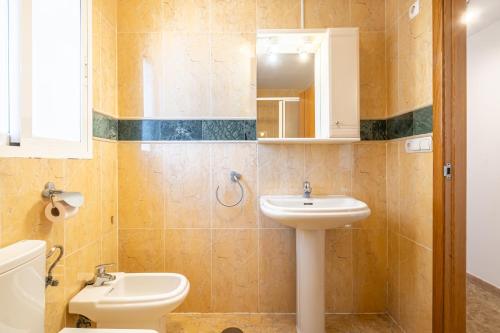 a bathroom with a sink and a toilet and a mirror at Acintur 13-A Apartment Levante Beach-Old Town in Benidorm