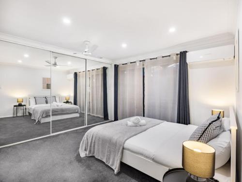 a bedroom with two beds and a large mirror at Private and Spacious 4BR Home with Parkview 5mins to Mall in Doolandella