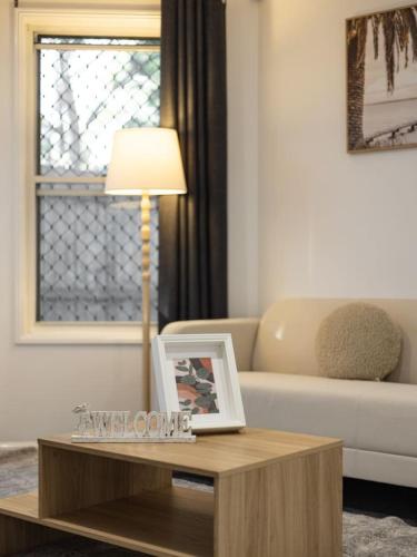 a living room with a coffee table and a couch at Private and Spacious 4BR Home with Parkview 5mins to Mall in Doolandella