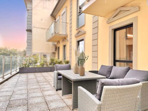 a patio with a table and chairs on a balcony at House of Art in Arezzo